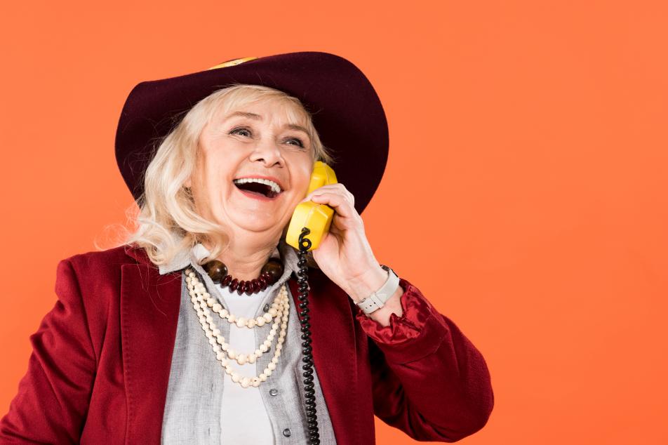 lady with hat and necklaces on telephone